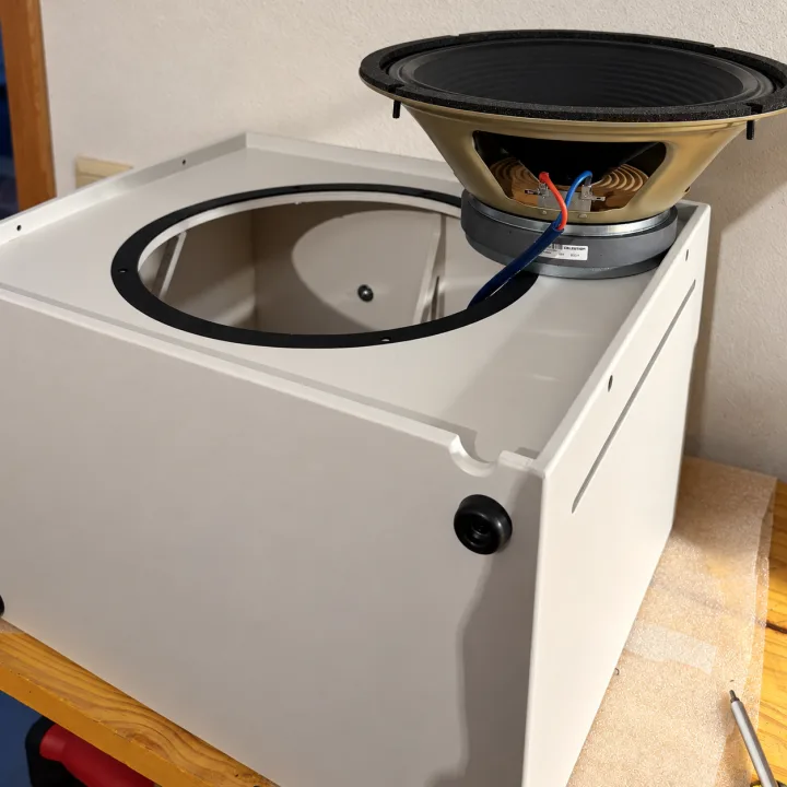 A Quasar cabinet on the Rawrawk workbench, with its speaker wiring and internal bracing visible