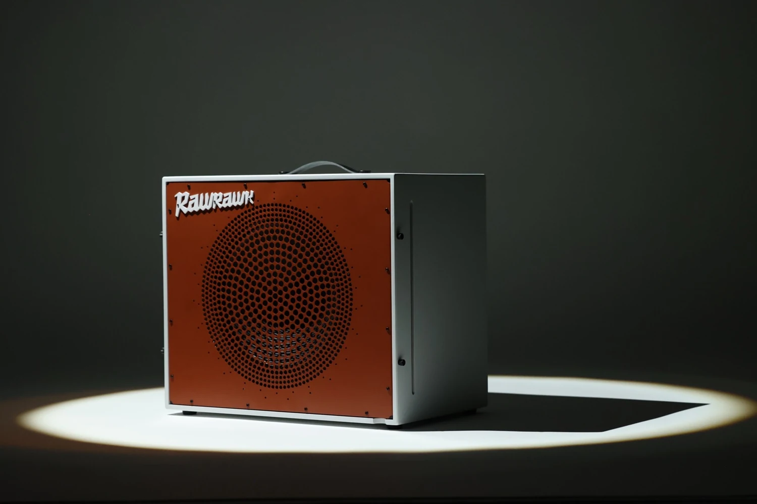 The complete Quasar cabinet with its Corten-colour Airframe, lit on a studio platform